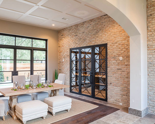 Dining room with wine room and brick interior wall