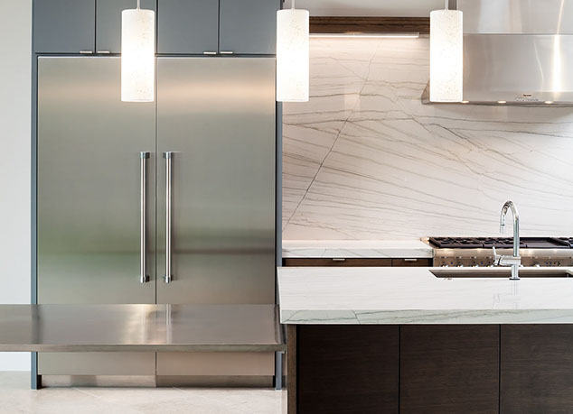 Modern gourmet kitchen with marble and stainless steel