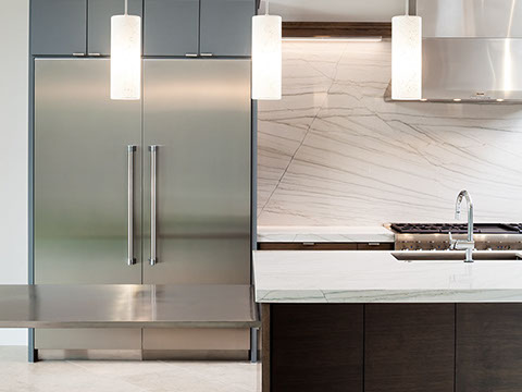 Modern gourmet kitchen with marble and stainless steel