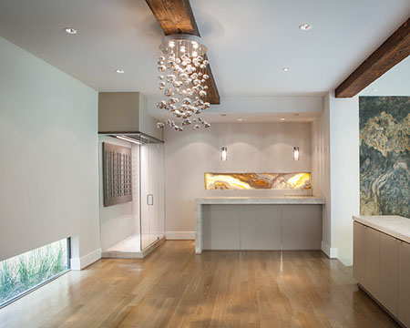 Modern bar with backlit stone and glass wine room