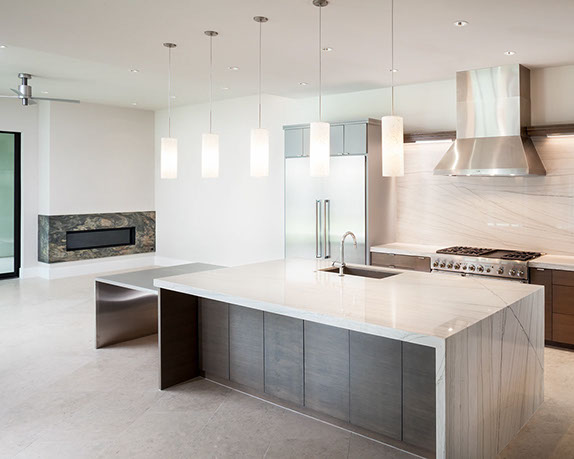 Gourmet kitchen with modern waterfall top island open to family room