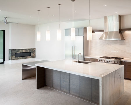 Gourmet kitchen with modern waterfall top island open to family room