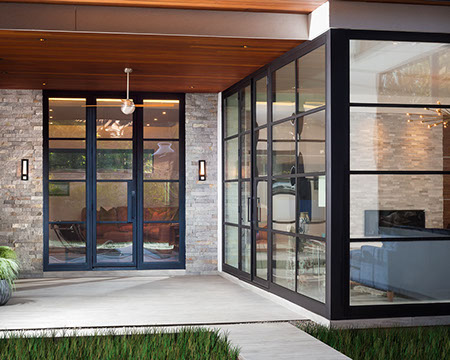 Corner window walls to outdoor living with fireplace